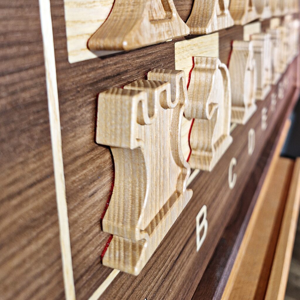 zbliżenie na drewniane figury szachowe na wiszącej szachownicy